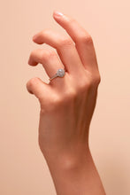 Load image into Gallery viewer, Lab Grown Diamond engagement ring. 9 carat white or yellow gold, set with a brilliant lab grown, round centre diamond framed by a round halo of pavé set diamonds. shown on hand