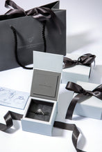 Load image into Gallery viewer, Lab Grown Diamonds in 9 carat white gold and set with a brilliant lab grown diamond centre stone framed by a halo of pavé set diamonds shown in white gift box with grey gift bag.