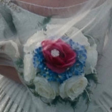 Load image into Gallery viewer, Blue hydrangeas surrounded by white roses with a single red rose in the center. 
