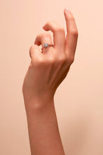 Load image into Gallery viewer,  Lab Grown Diamonds Beautifully crafted in 9 carat white gold and set with a brilliant lab grown diamond centre stone framed by a halo of pavé set diamonds shown on hand. 
